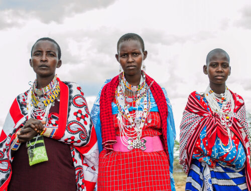 Trois femmes Maasaïs revêtues de leur tenue traditionnelle et de colliers divers